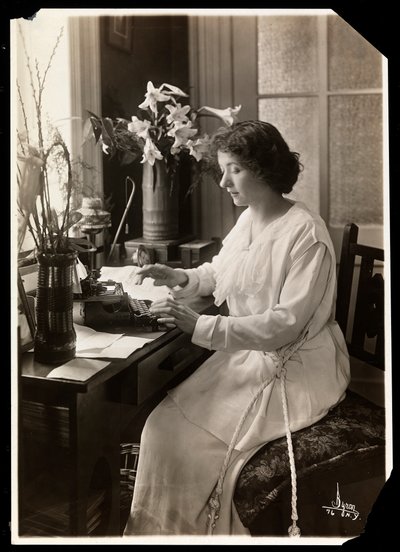 Maude Fealy seated at a typewriter, c.1915 by Byron Company